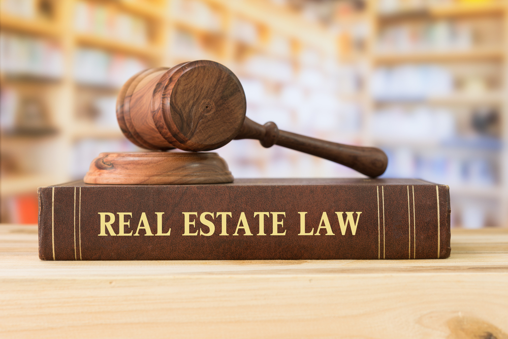 real estate law books and a gavel on desk in the library.