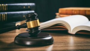Law studies. Judge gavel on a wooden desk, blur legal books