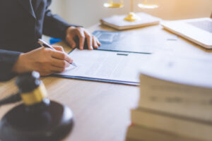 Lawyer business women working with contract papers and wooden gavel on tabel in courtroom.